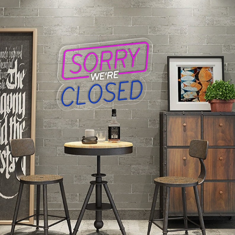 Sorry We Are Closed Business Neon Sign by Neon.Shop glowing above a shop entrance, letting customers know the business is closed