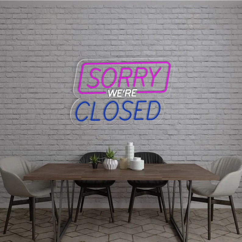 Sorry We Are Closed Business Neon Sign by Neon.Shop glowing above a shop entrance, letting customers know the business is closed