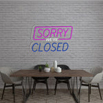 Sorry We Are Closed Business Neon Sign by Neon.Shop glowing above a shop entrance, letting customers know the business is closed