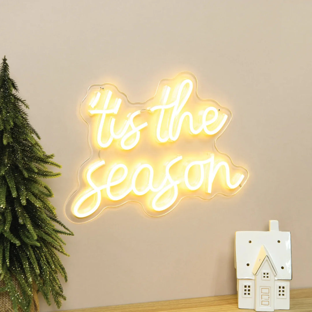 Tis The Season Merry Christmas Neon Sign by Neon.Shop glowing in LED light with festive lettering design.