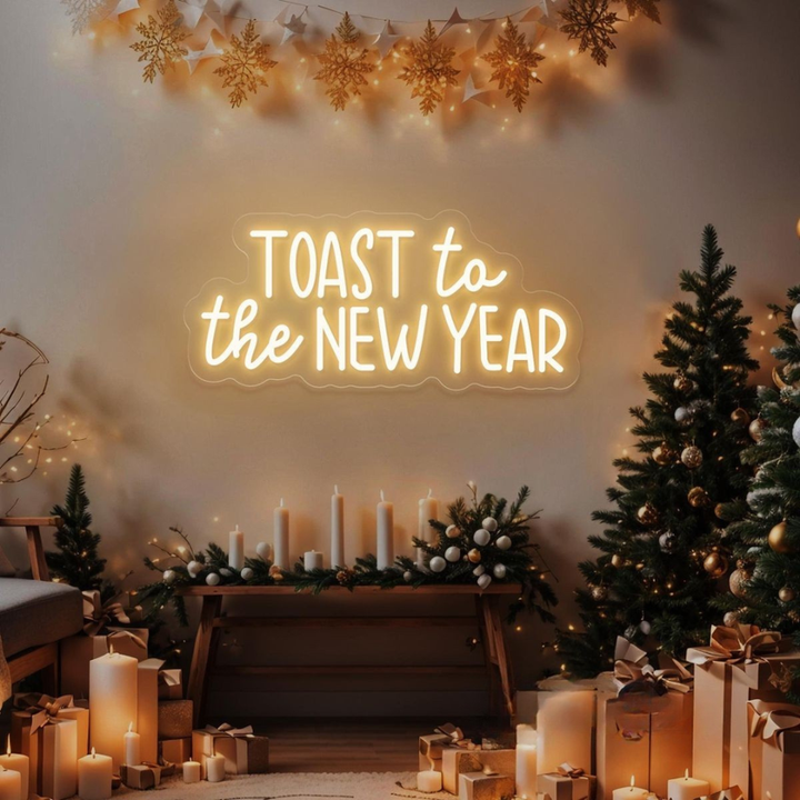 'Toast to the New Year' LED neon sign in a warm gold script font by Neon.Shop.