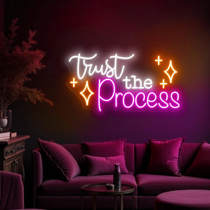 Trust The Process” neon sign illuminating a workspace, encouraging focus and perseverance by Neon.Shop.