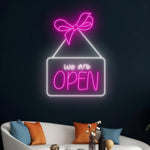 We Are Open Business Neon Sign by Neon.Shop glowing in a shop window