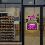 We Are Open Business Neon Sign by Neon.Shop glowing in a shop window