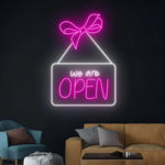 We Are Open Business Neon Sign by Neon.Shop glowing in a shop window
