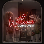 Welcome Come On In Business Neon Sign by Neon.Shop glowing in a shop window
