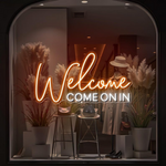 Welcome Come On In Business Neon Sign by Neon.Shop glowing in a shop window