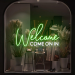 Welcome Come On In Business Neon Sign by Neon.Shop glowing in a shop window