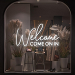 Welcome Come On In Business Neon Sign by Neon.Shop glowing in a shop window