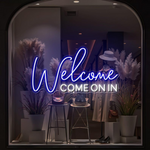 Welcome Come On In Business Neon Sign by Neon.Shop glowing in a shop window