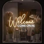 Welcome Come On In Business Neon Sign by Neon.Shop glowing in a shop window