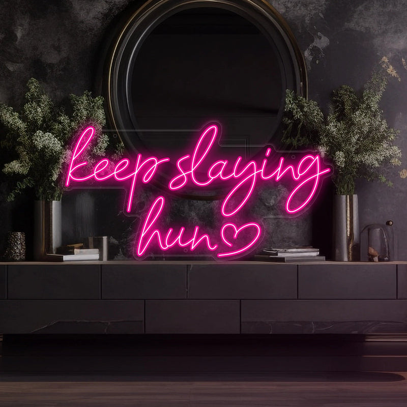 Keep Slaying Hun’ LED neon sign glowing brightly, ideal for beauty salons, glam rooms, and empowering home décor by Neon.Shop