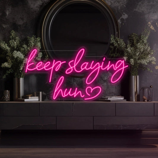 Keep Slaying Hun’ LED neon sign glowing brightly, ideal for beauty salons, glam rooms, and empowering home décor by Neon.Shop